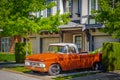 Retro pickup truck on a sunny summer day. Orange Chevrolet C10 Pick Up Truck. Vintage Chevy truck parked on a street