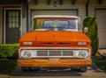 Retro pickup truck on a sunny summer day. Orange Chevrolet C10 Pick Up Truck. Vintage Chevy truck parked on a street Royalty Free Stock Photo