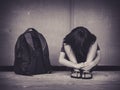 Sad Kid sitting on the floor with school bag waiting for parent. Royalty Free Stock Photo