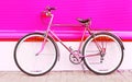 Retro pink bicycle stands over colorful pink
