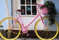 Beautiful pink and yellow bicycle parked in an English village Royalty Free Stock Photo