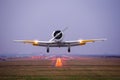 Retro plane fly up over takeoff runway from airport at twilight