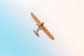 Retro plane with propeller flying across the sky in blue pink pastel colors