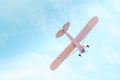 Retro plane with propeller flying and dives against the blue sky Royalty Free Stock Photo