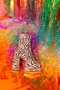 Retro platform zebra boots on party tinsel background. New year`s clubbing mood. Merry christmas. Holiday. Fashion and shine like