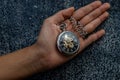 A retro pocket watch with chain in the palm of the girl`s hand Royalty Free Stock Photo