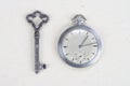 retro pocket watch and old vintage key on white background Royalty Free Stock Photo