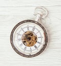 Retro pocket watch on the wooden background