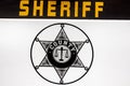 Retro police car, sheriff star sign on the door Royalty Free Stock Photo