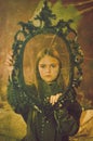 retro portrait of a little girl in a mirror frame. Royalty Free Stock Photo