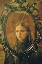 retro portrait of a little girl in a mirror frame. Royalty Free Stock Photo