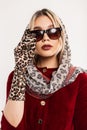 Retro portrait sexy young woman with beautiful lips in fashionable leopard scarf on head in stylish sunglasses in red elegant