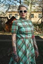 Retro Portrait of tattooed blonde Model with Dress and Sunglasses