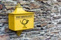 A retro postbox in yellow color in Marksburg, Germany.