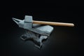 Retro profession concept, blacksmith, hard work, strength. Metal heavy anvil and hammer isolated on a dark background. 3D