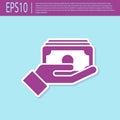 Retro purple Stacks paper money cash in hand icon isolated on turquoise background. Insurance concept. Money banknotes