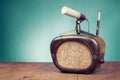 Retro radio and microphone on wooden table front mint blue background. Vintage style photo Royalty Free Stock Photo