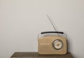 Retro radio receiver on wooden table against light grey background. Space for text Royalty Free Stock Photo