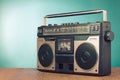 Retro radio recorder on wooden table front mint blue background. Vintage style filtered photo