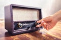 Retro radio tuning. Woman using old vintage music equipment. Adjusting volume or frequency tuner knob. Turning on or off stereo. Royalty Free Stock Photo