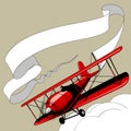 Retro red airplane with the ribbon banner in the sky Royalty Free Stock Photo