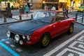 Retro red and black Lancia Fulvia car parked on a street in Madeira Portugal