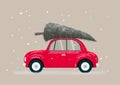 Retro red car with green christmas tree on roof Royalty Free Stock Photo