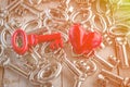 Retro red key with red heart on wooden table Royalty Free Stock Photo