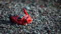 Retro red robot fallen over on rocks Royalty Free Stock Photo