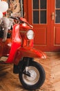 Retro red scooter  in oldschool vintage interior with air balloons. Royalty Free Stock Photo