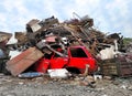 Retro red vehicle at junk yard. Broken steel garbage, vintage automotive parts and iron in heap waste for Recycling Royalty Free Stock Photo