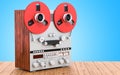 Retro reel-to-reel tape recorder on the wooden table. 3D rendering Royalty Free Stock Photo