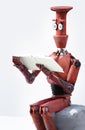 Retro robot reads a book on the stone. 3D render Royalty Free Stock Photo