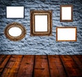 Retro room with antique picture frames on stone wall