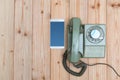 Retro rotary telephone or vintage phone with cable and new cell Royalty Free Stock Photo