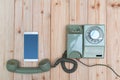 Retro rotary telephone or vintage phone with cable and new cell Royalty Free Stock Photo