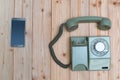 Retro rotary telephone or vintage phone with cable and new cell phone or smart phone on wood table, top view with copy space, Royalty Free Stock Photo