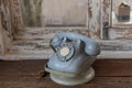 Retro rotary telephone on wood table. Vintage telephone. grey old phone. Retro telephone on table in front windows background. Royalty Free Stock Photo