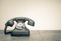 Retro rotary telephone on wooden table. Vintage style sepiaphoto Royalty Free Stock Photo