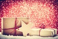 Retro rustic Christmas gifts, presents in snow on glitter background