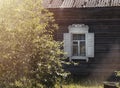 Retro rustic window with shutters over log wall of old ancient village house in summer Royalty Free Stock Photo
