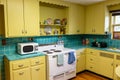 Retro 1940s style kitchen with yellow cabinets and blue tile, at the historic Carpenter House - Hollywood, Florida, USA