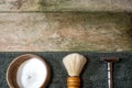 Retro safety razor, shaving brush and lather in bowl. Old-school wet shaving in rustic wooden table, with copy space. Royalty Free Stock Photo