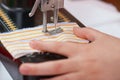 Retro sewing machine and child hand closeup, handmade and handicraft concept