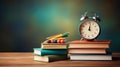 Retro silver alarm clock, books on a wooden table, blurred green school board background with copy space, back to school concept, Royalty Free Stock Photo