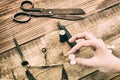 Retro silver coin in women`s hand. Tools to create vintage money by coinage. Reconstruction of ancient tools for making coins