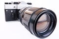 Retro SLR camera with telephoto lens Royalty Free Stock Photo