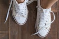 Retro sneakers left on wooden floor Royalty Free Stock Photo