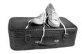 Retro sneakers on old leather suitcase isolated on white background. The concept of travel. Royalty Free Stock Photo