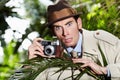 Retro spy man, camera and jungle for investigation, inspection or journalist with shock at job. Private investigator